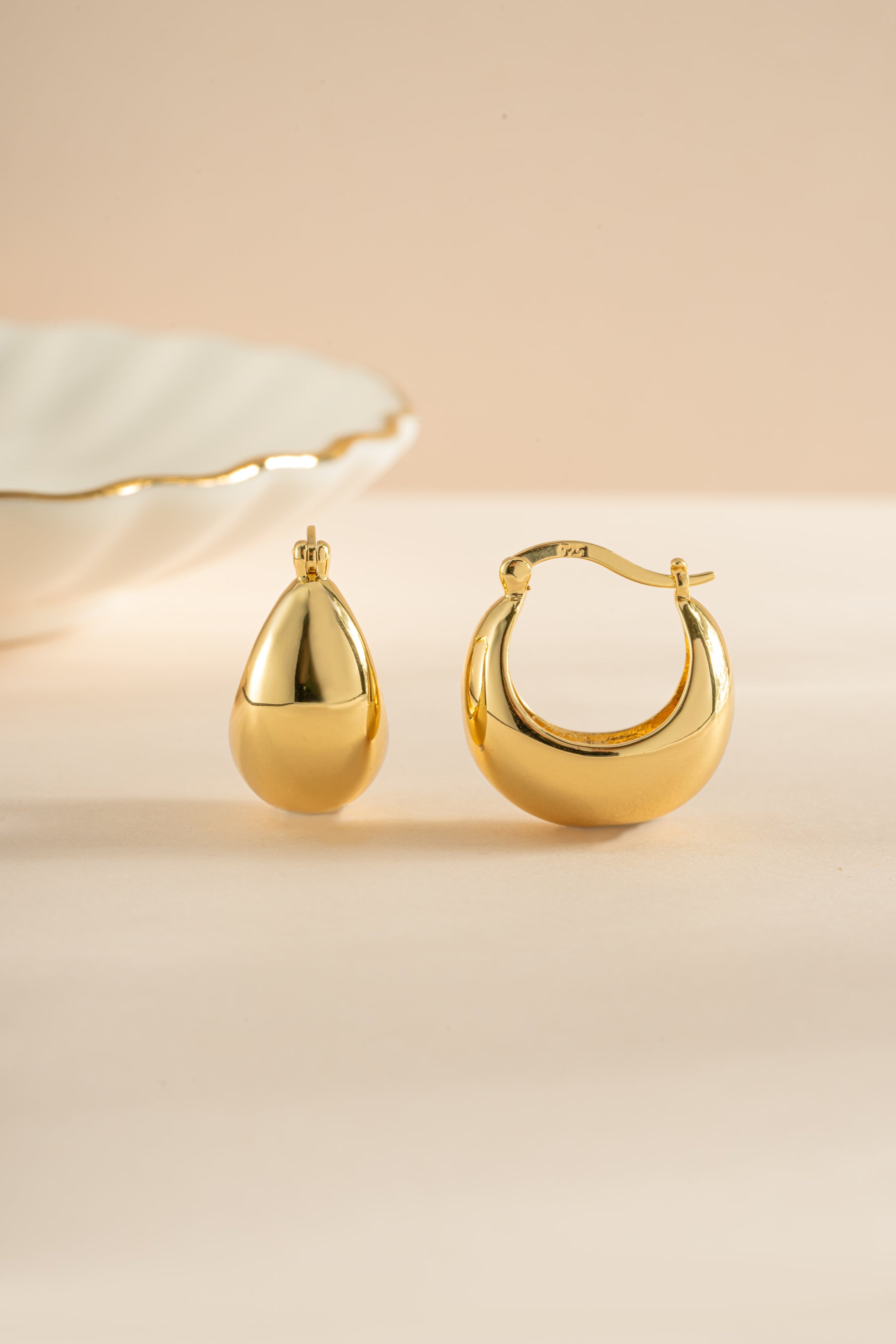Gold chunky basket tube hoop earrings by Sami Jewels with bold, textured design and thick, rounded hoops.