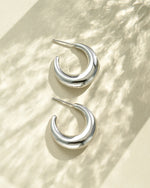 Close-up of SS Gradient Hoops earrings by Sami Jewels, chunky silver crescent hoop earrings made of stainless steel.
