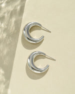 Close-up of silver stainless steel SS Gradient Hoops earrings featuring chunky crescent design by Sami Jewels.
