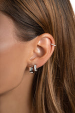 Sterling silver small chunky hoop earrings styled on a model, featuring bold, rounded design from Sami Jewels.