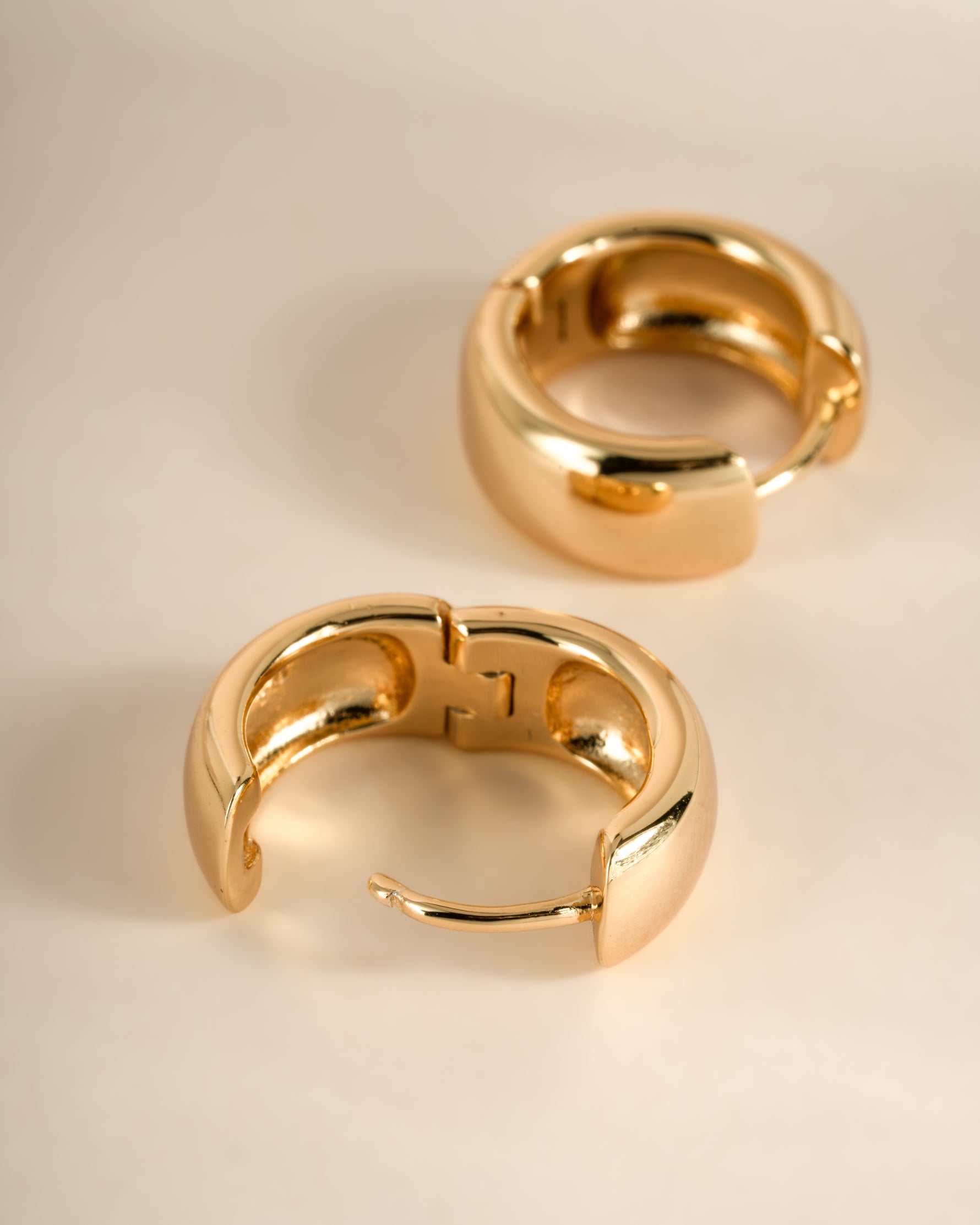 Gold Chunky Olivia Hoop Earrings by Sami Jewels, angled view showing bold, chunky hoop design with a smooth, polished finish.