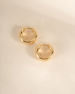 Gold Chunky Olivia Hoops by Sami Jewels, large huggie earrings with a bold, rounded design, shown from a side view.