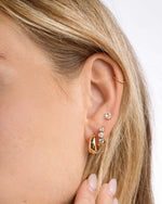 Gold 15mm chunky huggie earrings by Sami Jewels worn on a model, showcasing their bold, modern design and thick hoop style.
