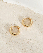 Sami Jewels 15mm chunky huggie hoops earrings in gold with a thick, rounded profile on a white background.