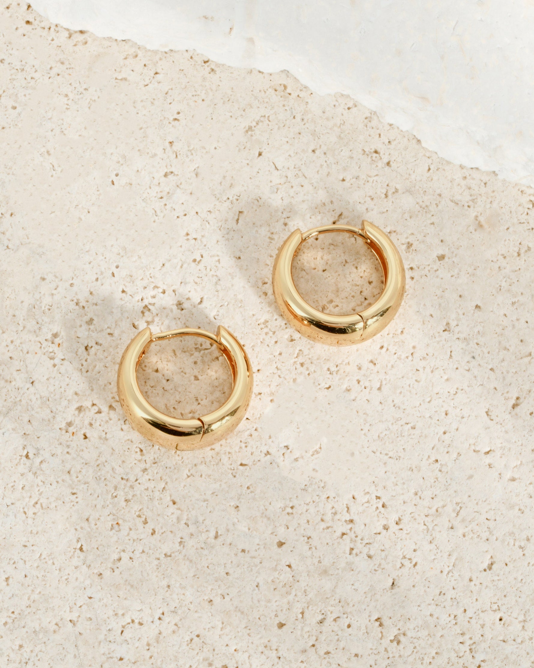 Sami Jewels 15mm chunky huggie hoops earrings in gold with a thick, rounded profile on a white background.
