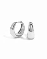 Silver 15mm chunky huggie hoops earrings by Sami Jewels displayed on a white background.