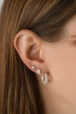 Gold chunky pavé hoop earrings from Sami Jewels showcased on a styled model. Durable, stylish jewelry accessory.