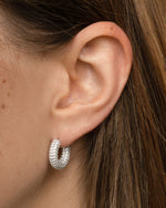 Sterling silver chunky pavé hoop earrings from Sami Jewels, featuring bold, sparkling design on a model.