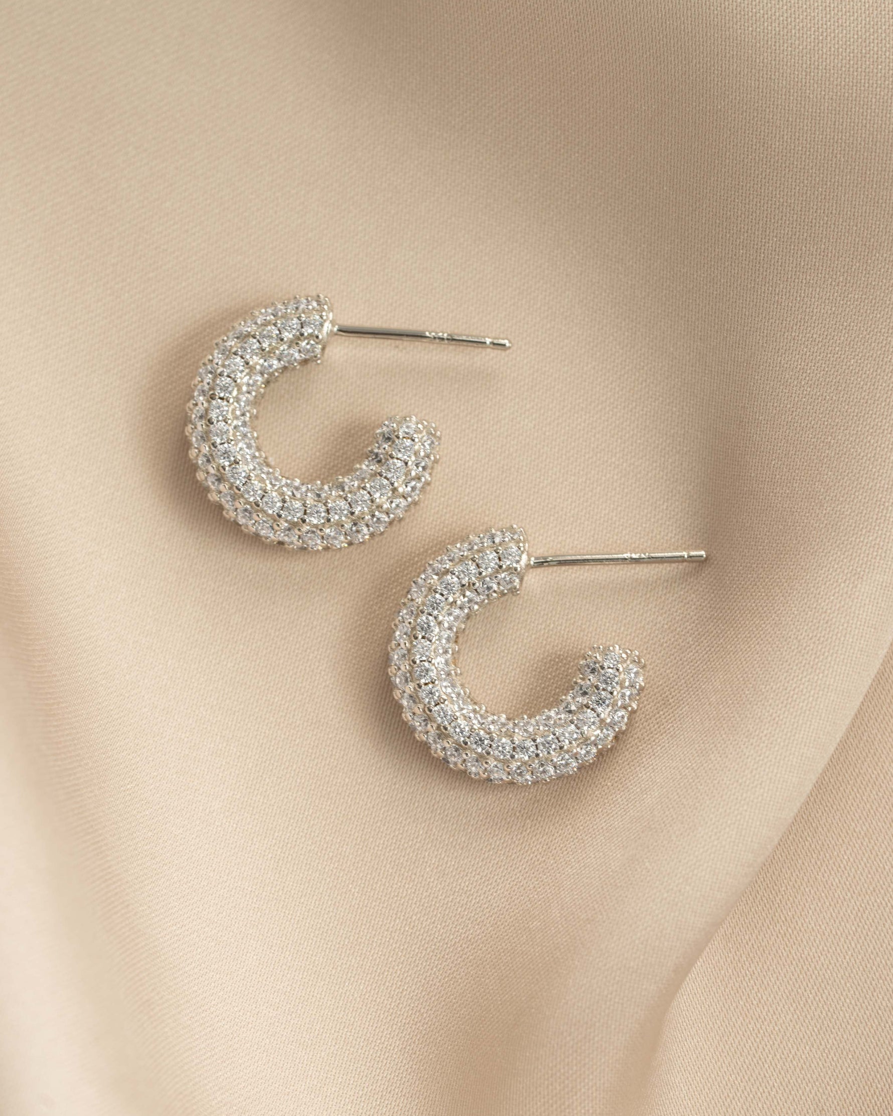 Sterling silver Sami Jewels chunky pavé hoop earrings with sparkling embedded stones.