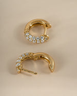 Close-up of gold Sami Jewels chunky pavé huggie earrings showcasing their bold, sparkling design.