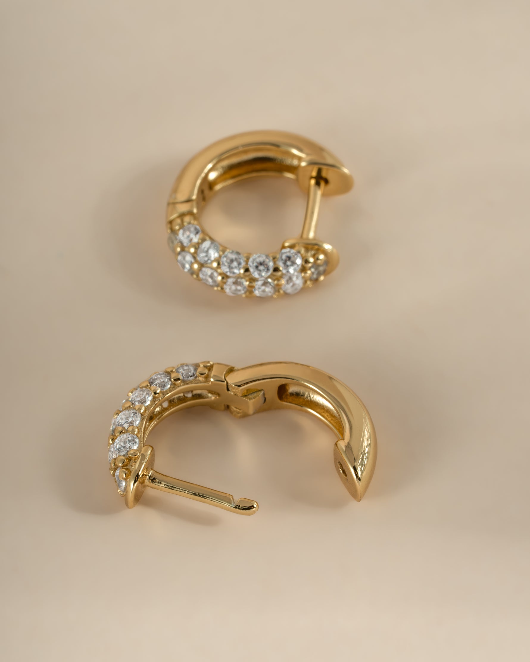 Close-up of gold Sami Jewels chunky pavé huggie earrings showcasing their bold, sparkling design.