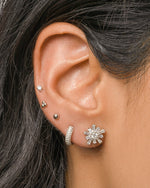 Sterling silver Sami Jewels chunky pavé huggie earrings featuring sparkling pave details on a model.