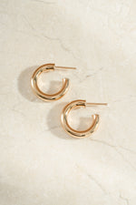 chunky tube hoop earrings in 24mm in gold side view 