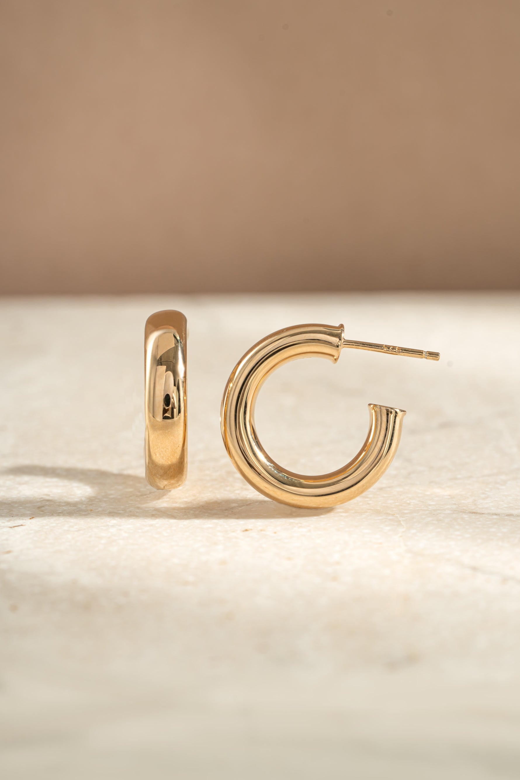 chunky tube hoop earrings in 24mm in gold closeup