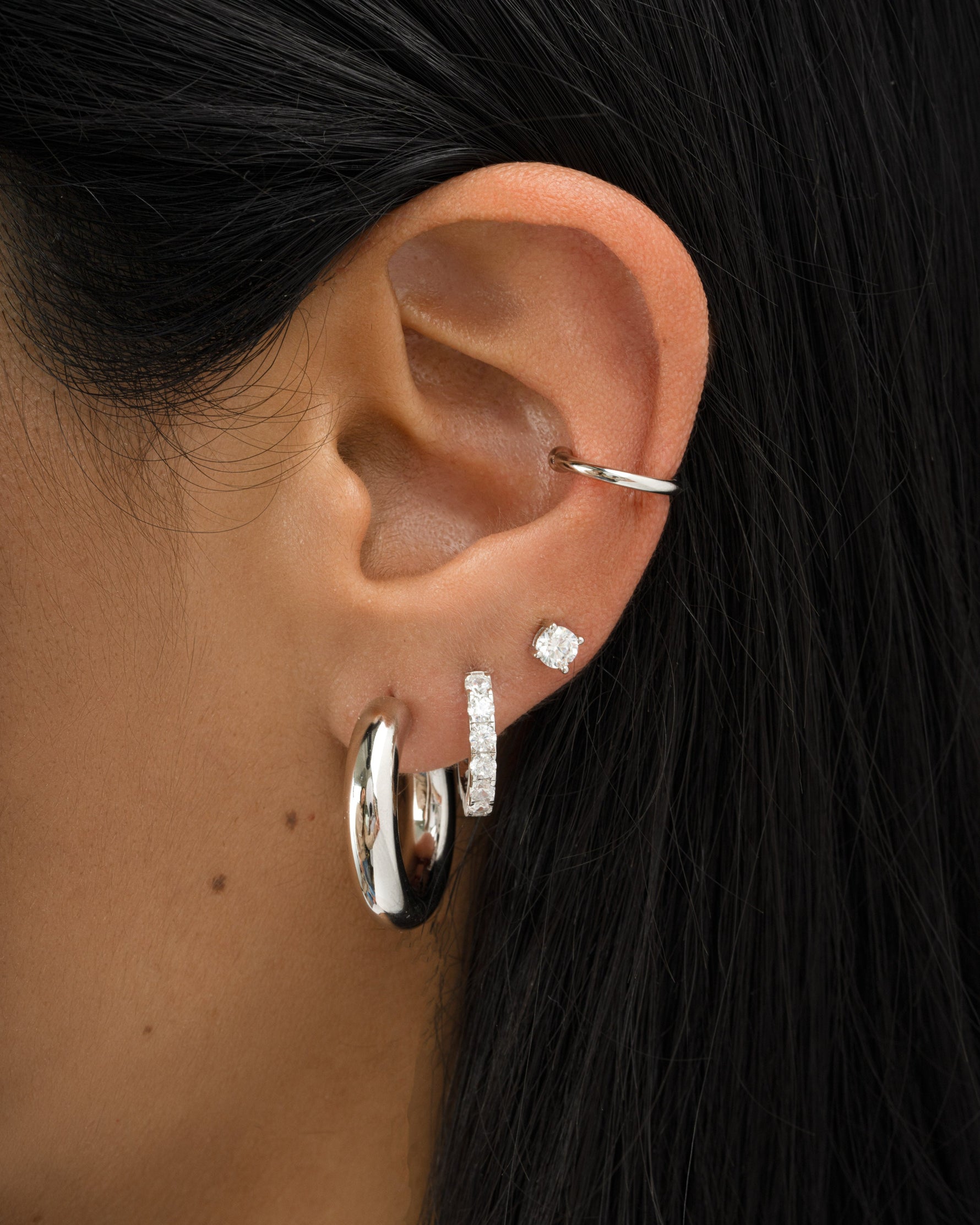 chunky tube hoop earrings in 24mm in sterling silver on models ear
