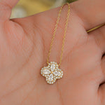 Close-up of a four leaf clover necklace with intricate diamond design