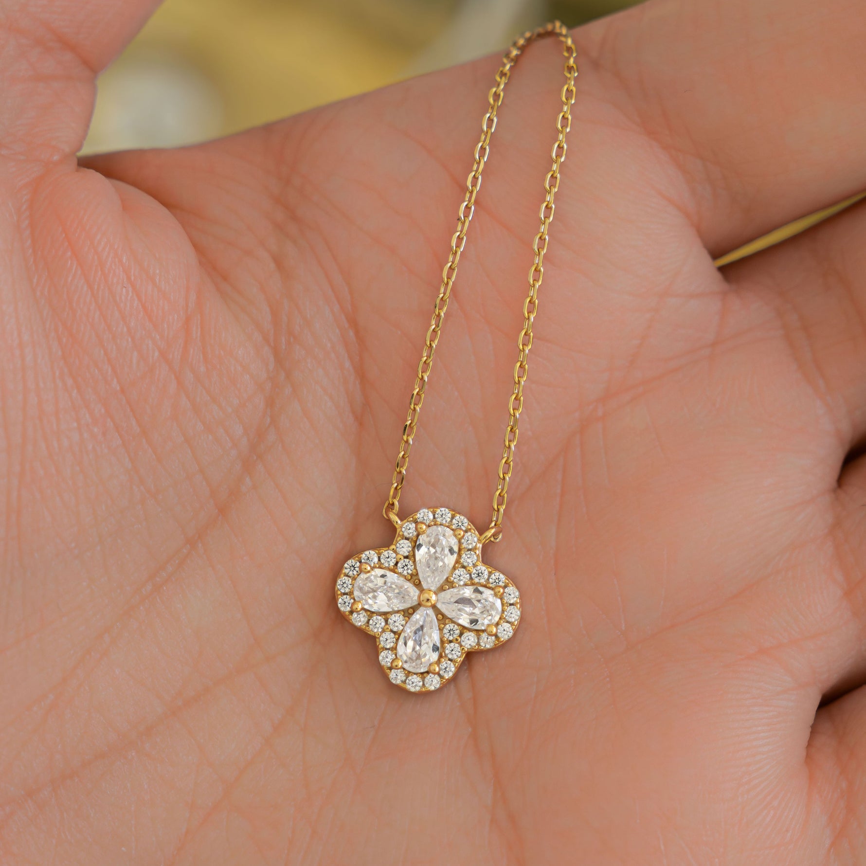 Close-up of a four leaf clover necklace with intricate diamond design