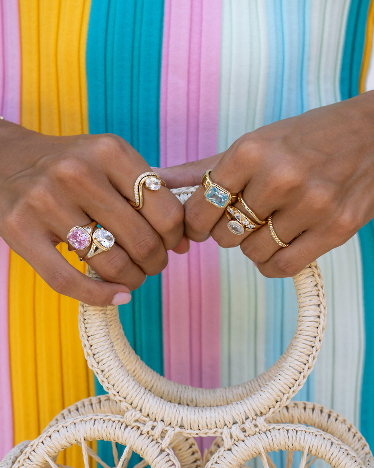 Pink elongated gemstone cushion ring by Sami Jewels featuring a gold band and vibrant colored gemstone detail.