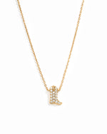 A delicate gold chain necklace featuring a small cowboy boot pendant paved with cz crystals, shown against a plain white background.