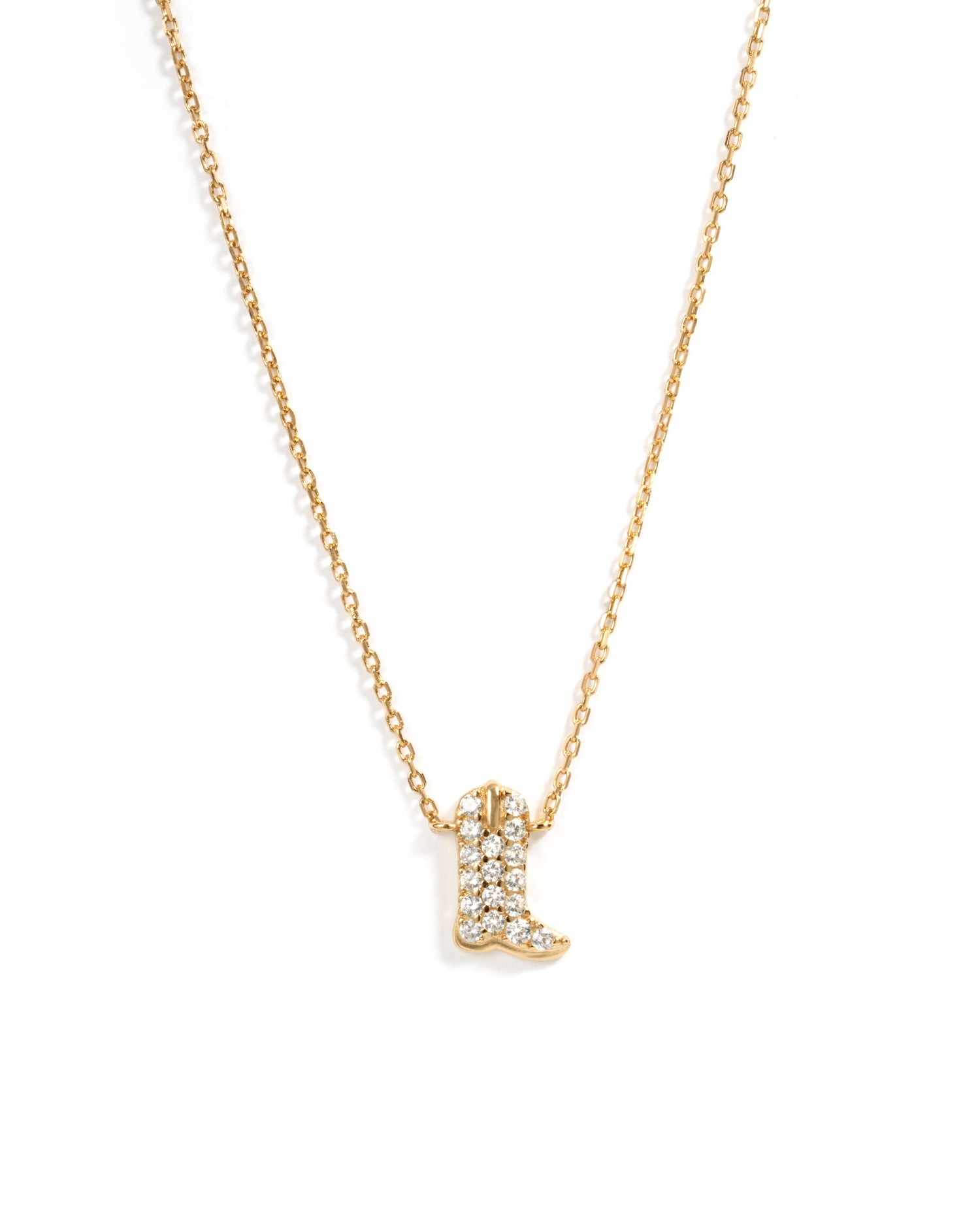 A delicate gold chain necklace featuring a small cowboy boot pendant paved with cz crystals, shown against a plain white background.