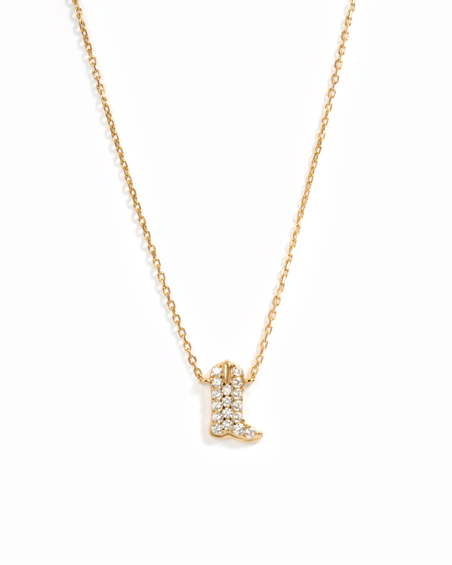 A delicate gold chain necklace featuring a small cowboy boot pendant paved with cz crystals, shown against a plain white background.