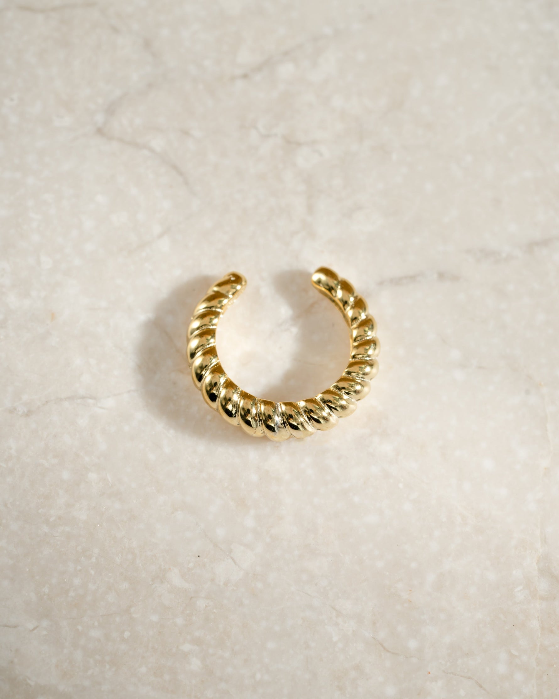 Gold croissant ear cuff earring from Samijewels-527, showcasing a textured, curved design for a stylish accessory.