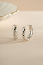 Sterling silver Jacky hoop earrings by Sami Jewels featuring a croissant-shaped design.