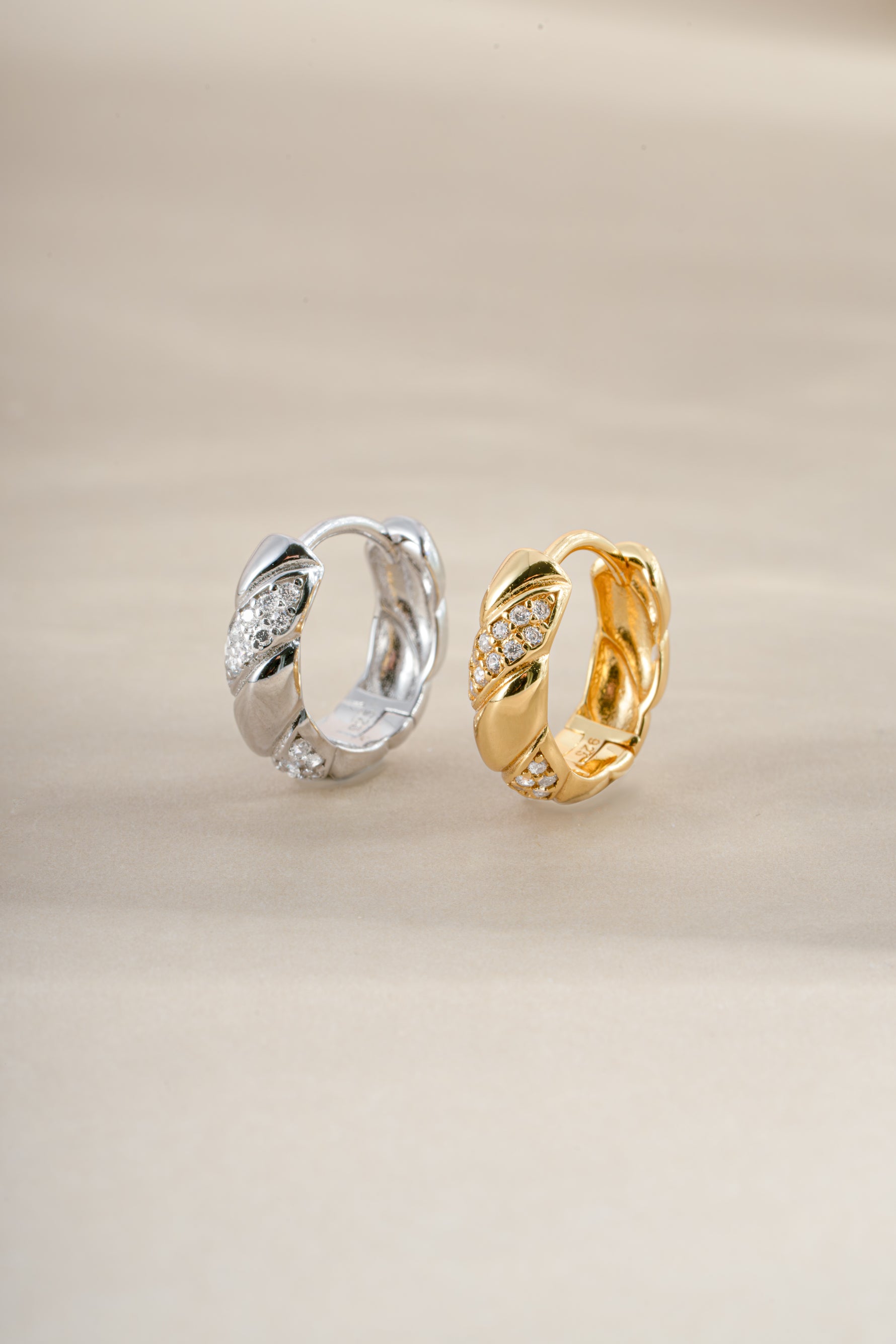 Gold and sterling silver croissant-shaped studded hoops earrings by Sami Jewels with textured, fashionable design.