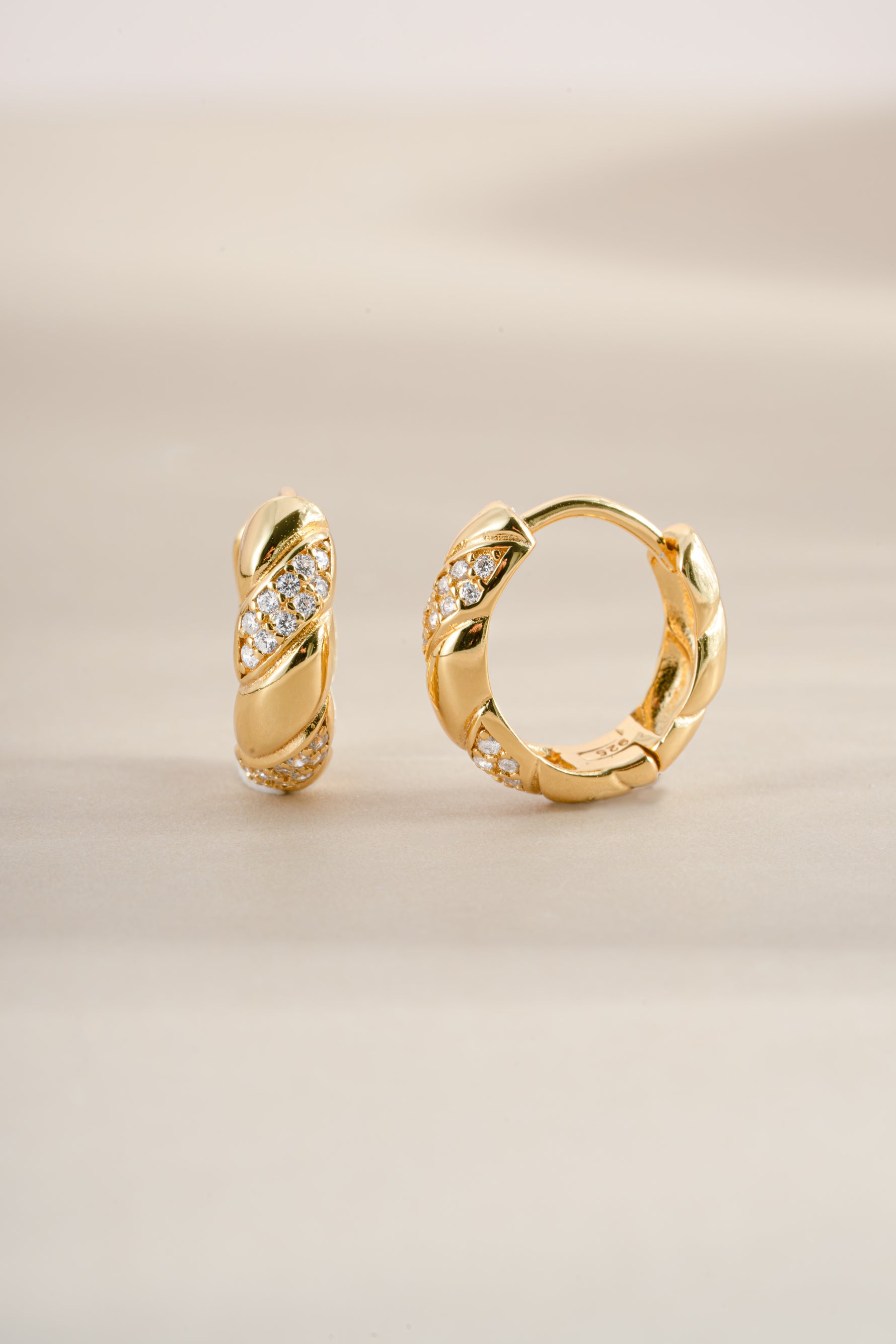 Gold studded croissant hoop earrings from Sami Jewels, angled view showcasing textured surface and hoop design.