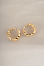 Gold studded croissant hoop earrings by Sami Jewels featuring textured, curved design for a stylish, modern look.