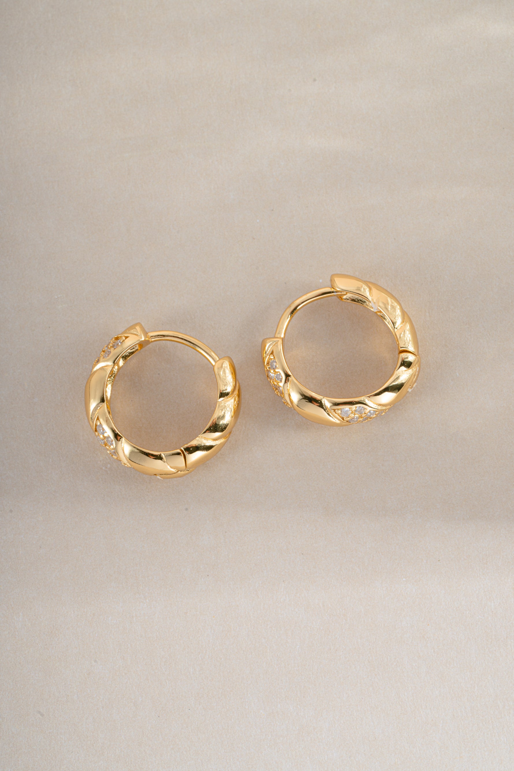 Gold studded croissant hoop earrings by Sami Jewels featuring textured, curved design for a stylish, modern look.