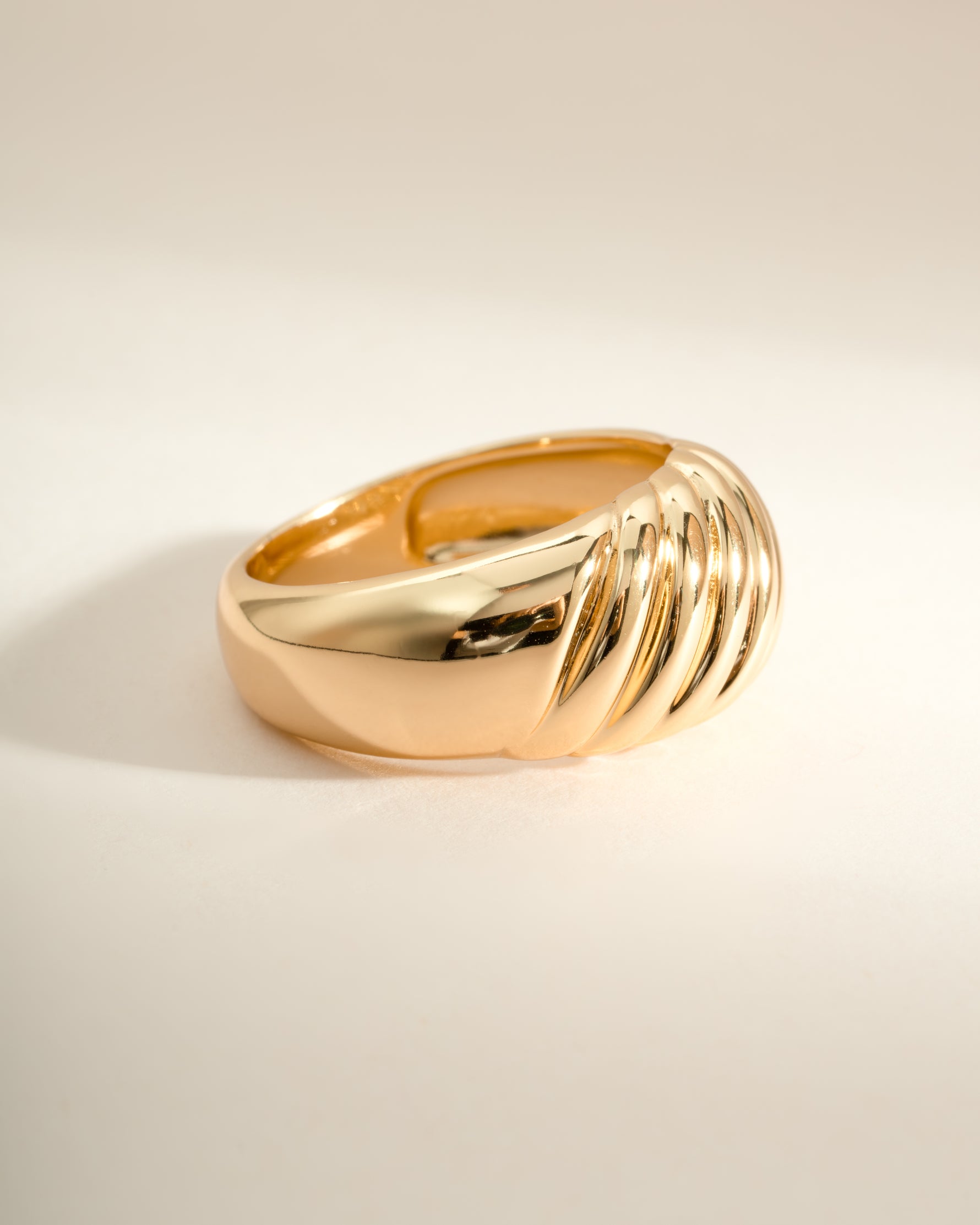 Gold large croissant statement ring from Sami Jewels, side view showing detailed croissant design on a sleek ring band.