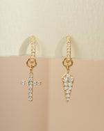 Gold Sami Jewels Cross and Dagger Charm Huggies earrings with detailed front view, showcasing unique dangling charm design.