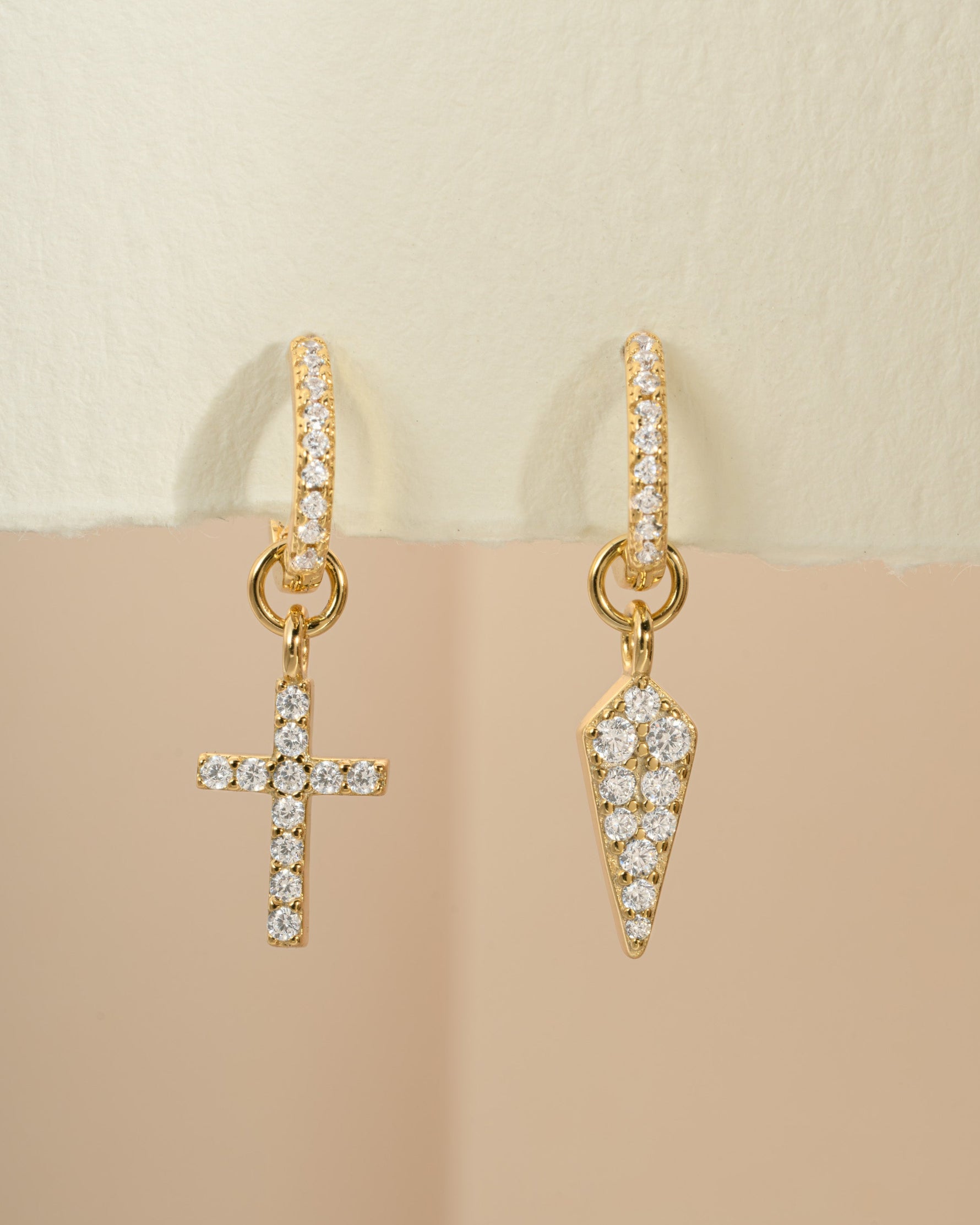 Gold Sami Jewels Cross and Dagger Charm Huggies earrings with detailed front view, showcasing unique dangling charm design.