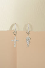 Sterling silver Cross and dagger charm huggie earrings by Sami Jewels, showcasing detailed small hoop earrings with charm accents.