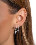Sterling silver cross and dagger charm huggie earrings by Sami Jewels, featuring detailed design and hoop style for pierced ears.