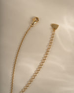 Gold cross necklace from Sami Jewels featuring a lobster clasp closure, designed for elegant jewelry styling.