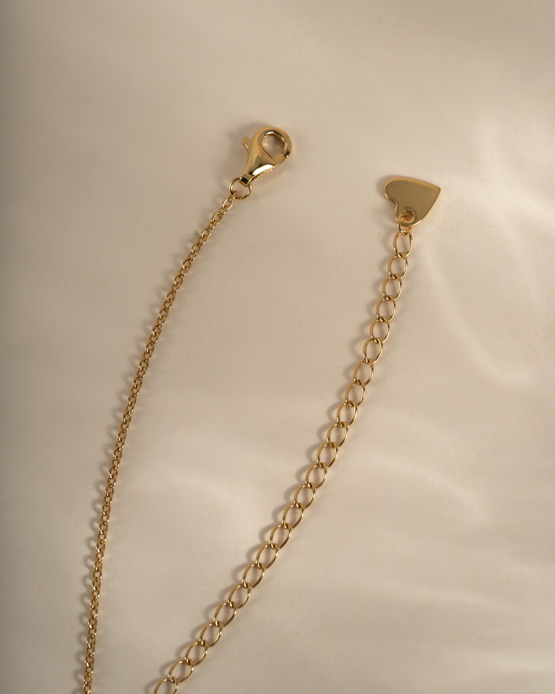Gold cross necklace from Sami Jewels featuring a lobster clasp closure, designed for elegant jewelry styling.