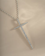 Sterling silver cross necklace by Sami Jewels, close-up showing detailed design and chain link on a plain background.