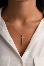 Sterling silver cross necklace by Sami Jewels, featuring a smooth, polished cross pendant on a delicate chain.
