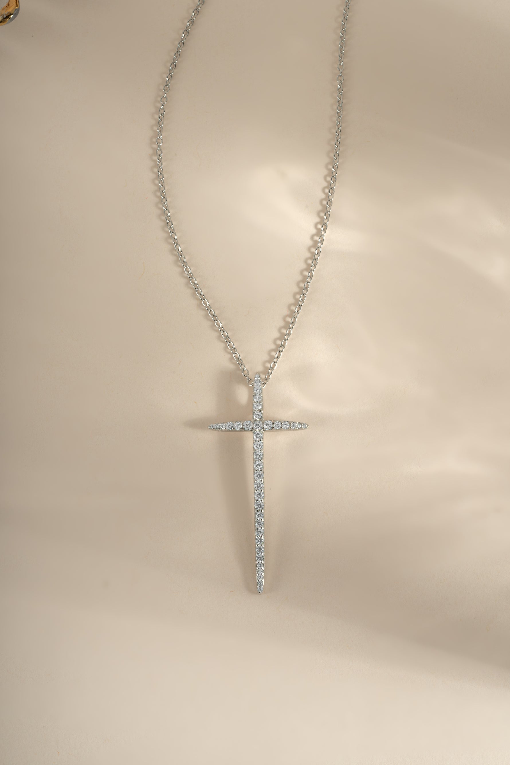 Sterling silver cross necklace from Sami Jewels featuring a simple, elegant pendant design on a chain.