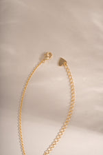 Gold cross pendant necklace with lobster clasp closure from Sami Jewels, featuring a sleek and elegant design.