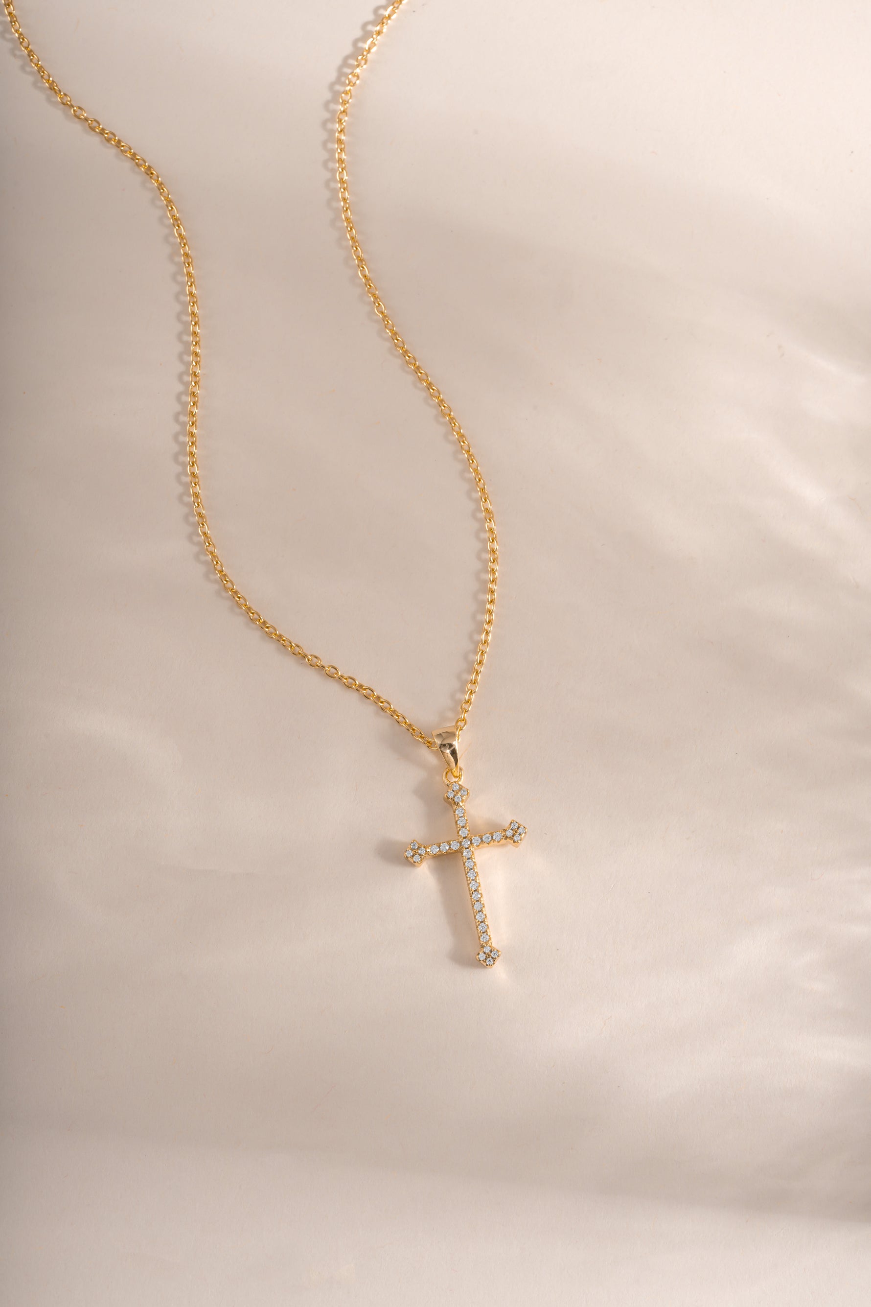 Gold cross pendant necklace by Sami Jewels featuring a sleek, elegant design perfect for everyday wear.