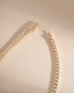 Close-up of Sami Jewels Square Tennis Necklace with cushion bezel cubic zirconia stones in gold.