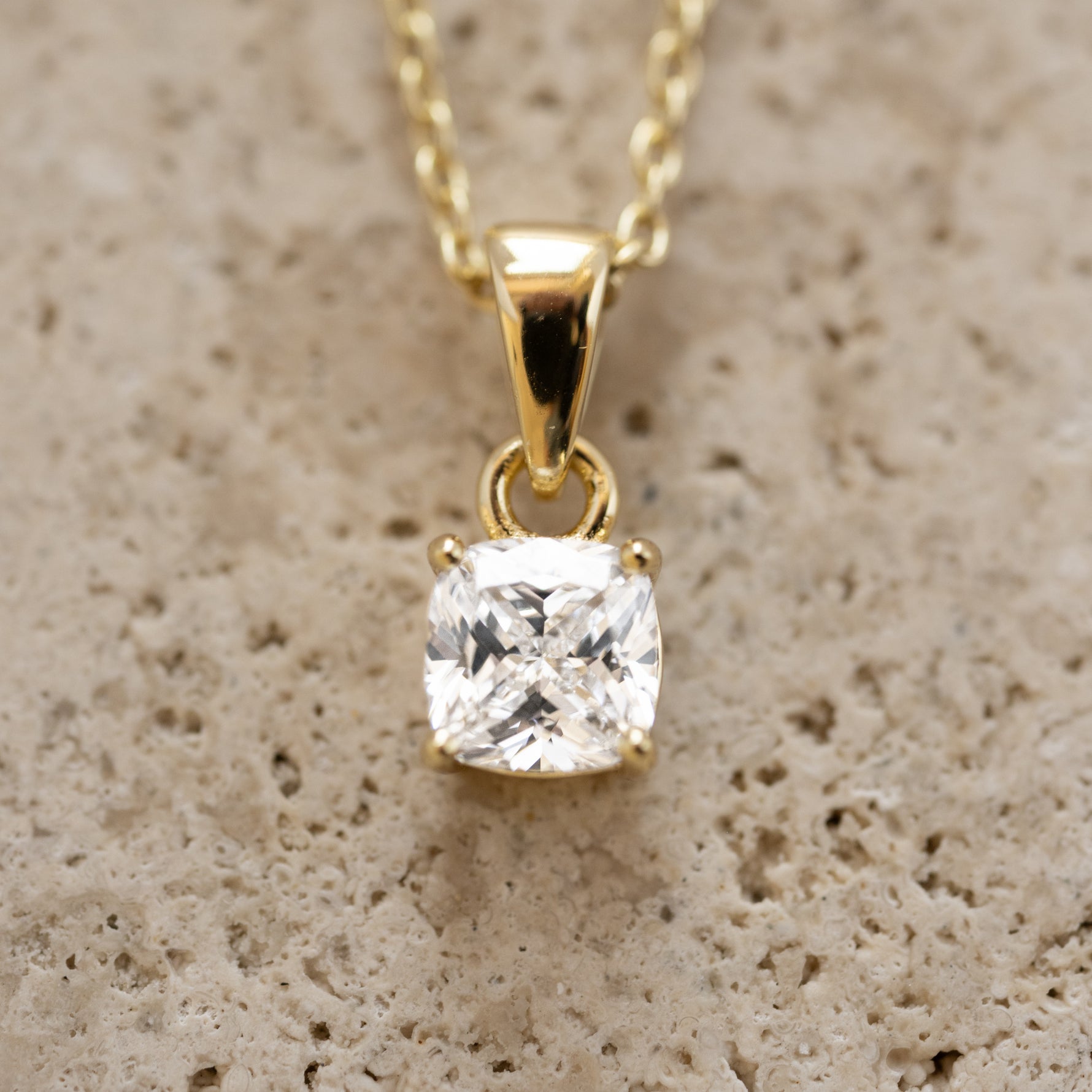 Gold cushion diamond pendant necklace from Sami Jewels, featuring a sparkling diamond centerpiece and elegant chain.