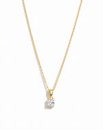 Gold cushion diamond pendant necklace by Sami Jewels displayed on a white background.