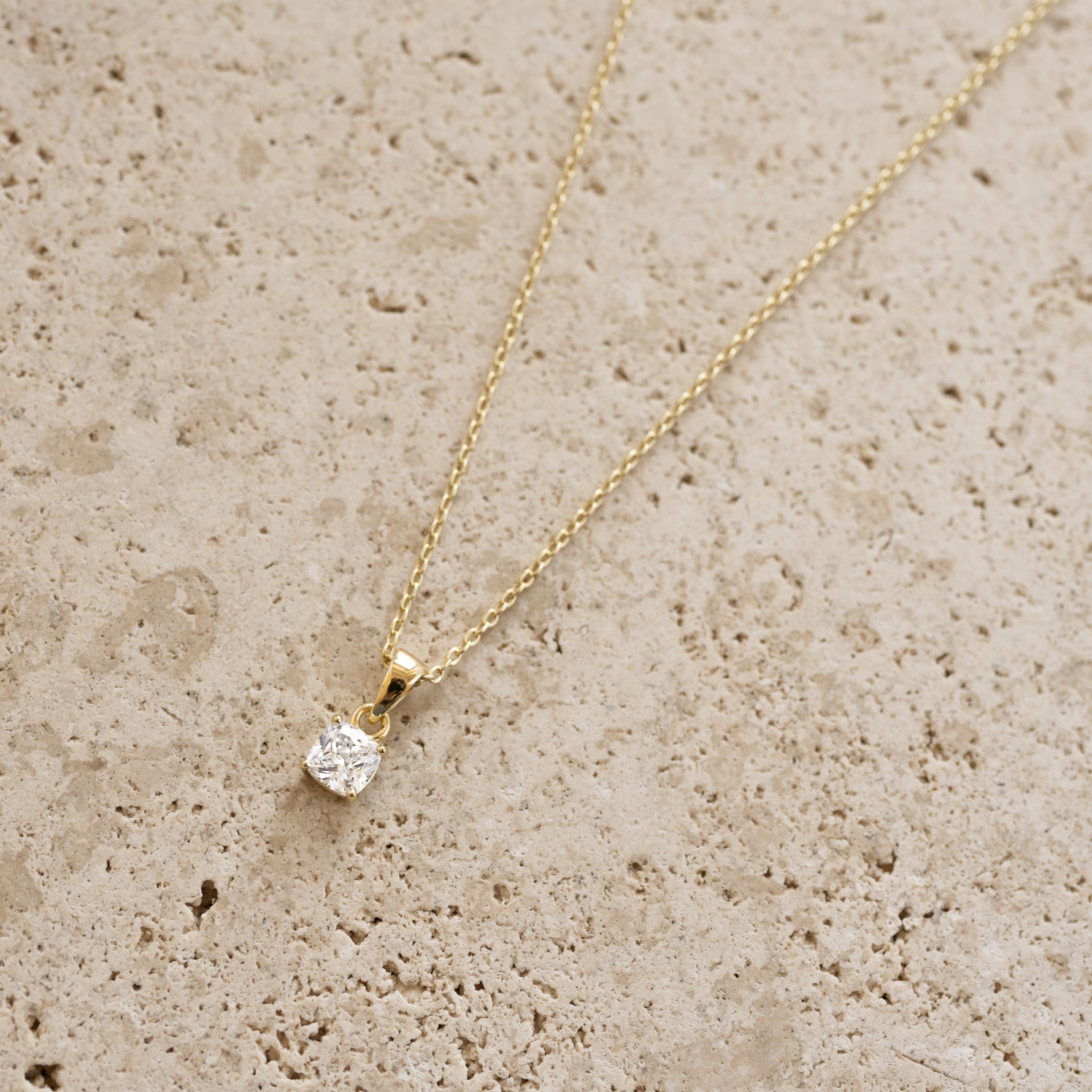 Gold cushion diamond pendant necklace by Sami Jewels, featuring a sparkling diamond centerpiece on a delicate chain.