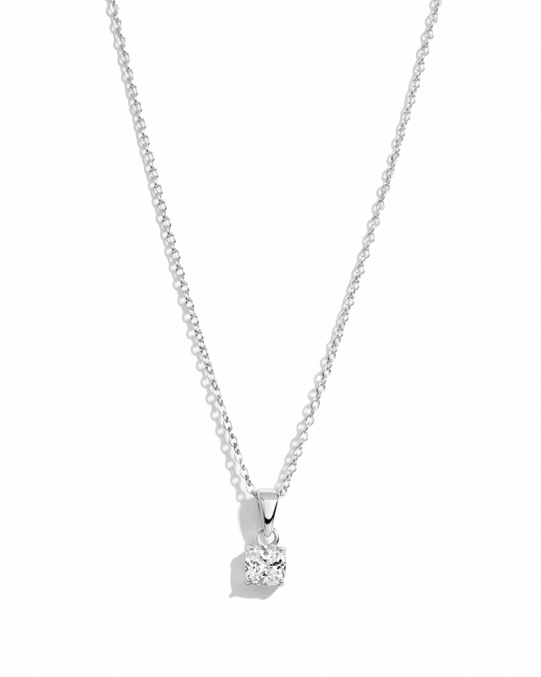 Sterling silver cushion diamond necklace by Sami Jewels with a sparkling central diamond pendant on a white background.