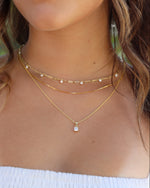 Sami Jewels cushion diamond pendant necklace styled on a model, showcasing elegant jewelry with a sparkling cushion-cut diamond.