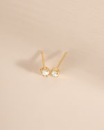 Gold top-view of Sami Jewels opal and cubic zirconia stud earrings showcasing their sparkling gemstones and elegant design.